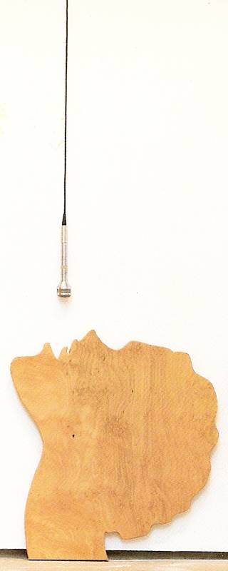 silhouette of person's profile looking up with microphone on cable hanging above mouth